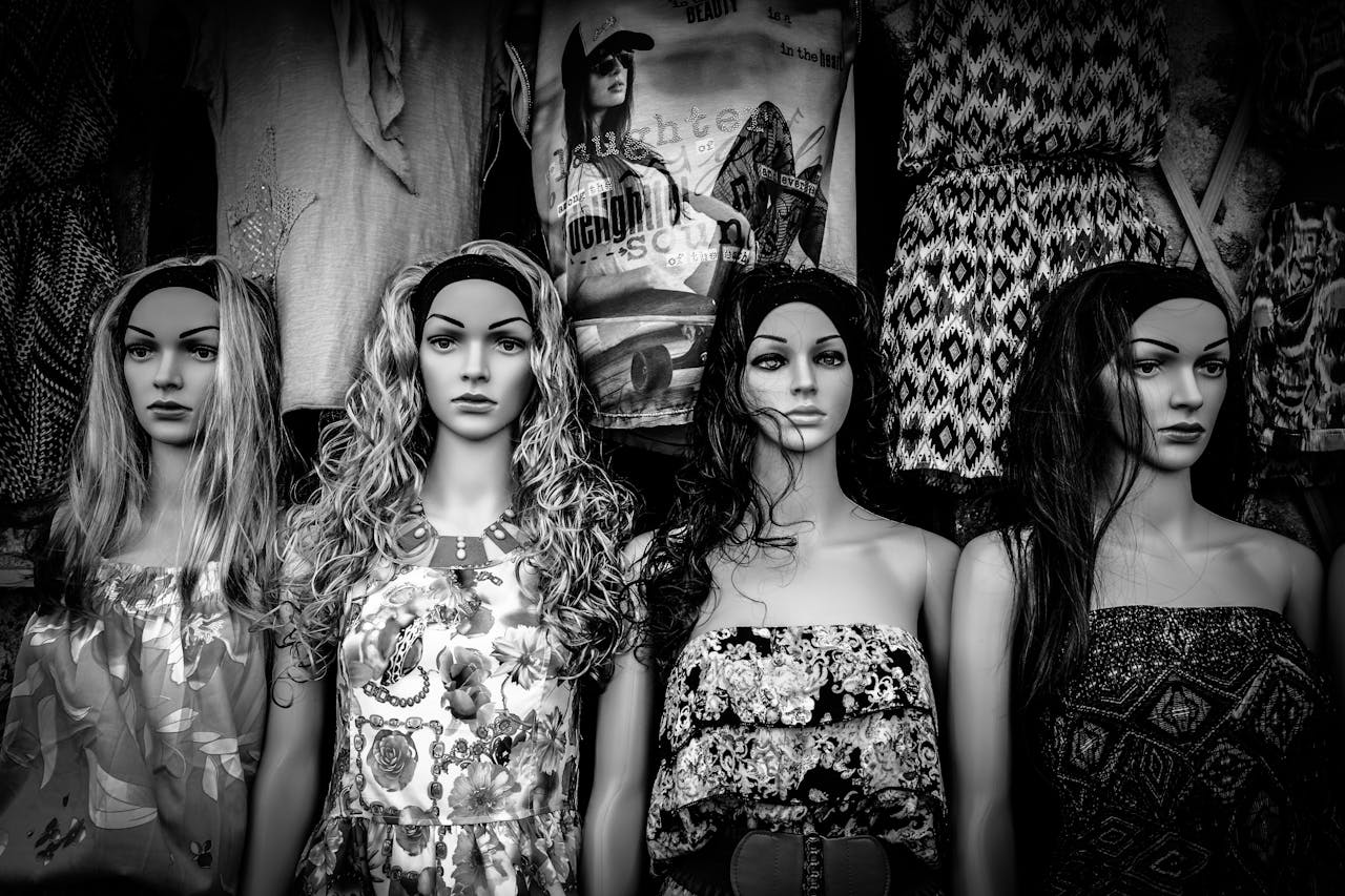 Stylish black and white display of mannequins wearing varied fashion dresses.